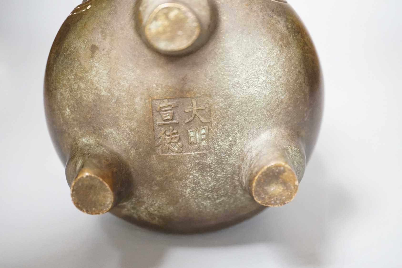 A Chinese bronze tripod Islamic market censer, Xuande mark - 13cm tall
